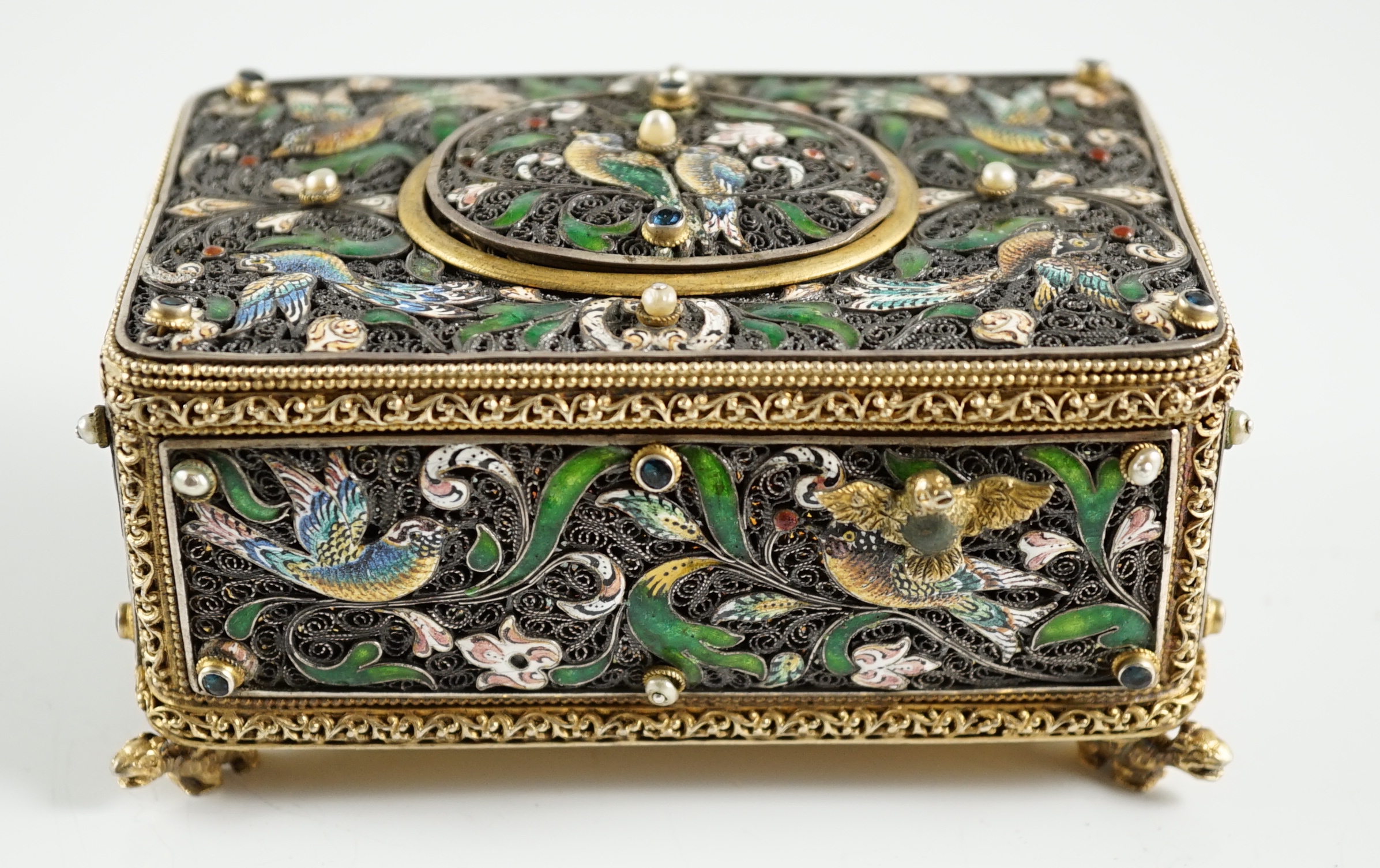 A 19th century Austro-Hungarian 800 standard silver gilt, jewelled and enamelled rectangular singing bird box automaton